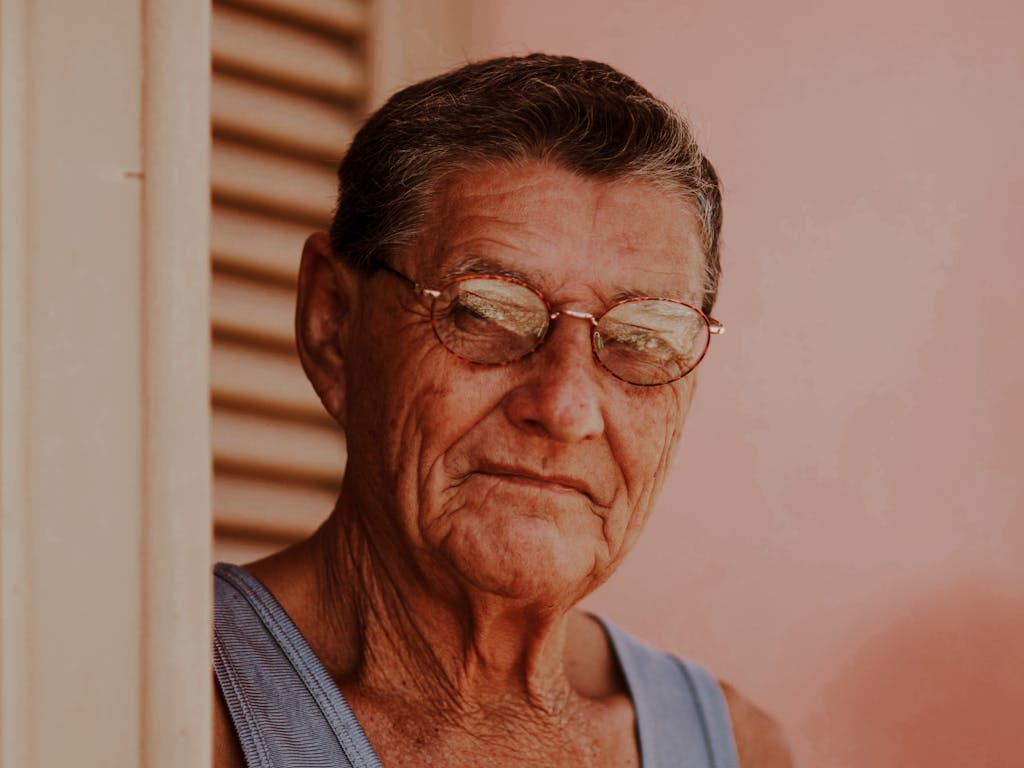 Portrait of an elderly man wearing glasses, exuding wisdom and tranquility.